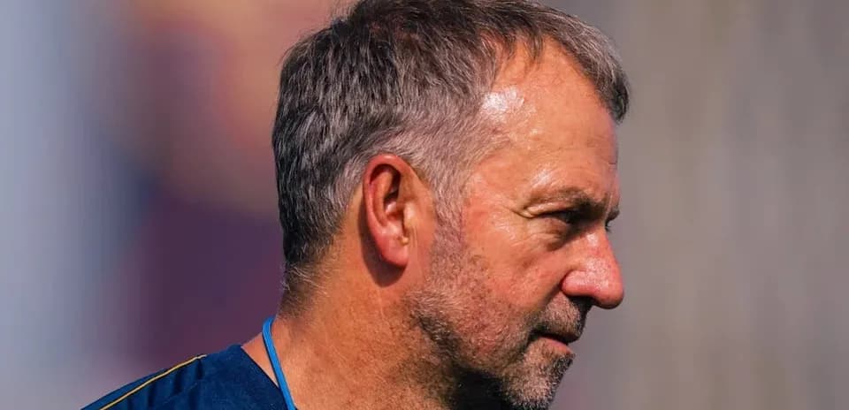 Coach observing players during training session