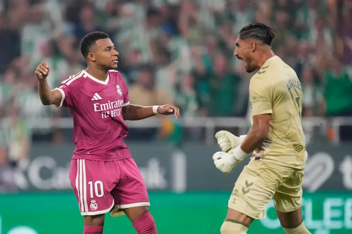 Player celebrating while goalkeeper reacts during match