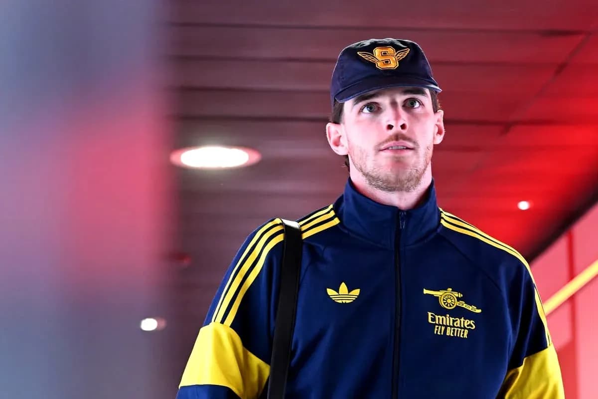 Player walking through airport terminal in team tracksuit