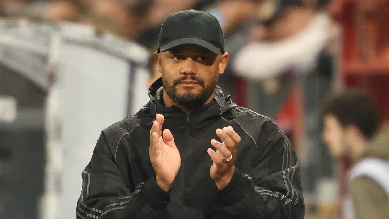 Coach applauding from the sidelines during match