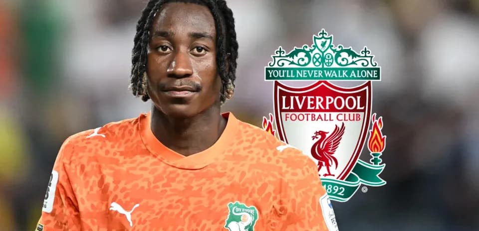 Player in orange kit with Liverpool logo background