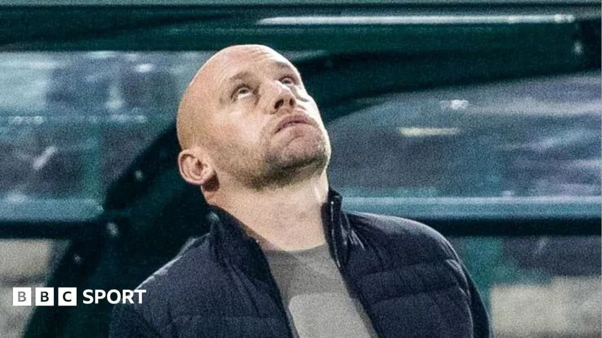 Coach looking up from the dugout during match