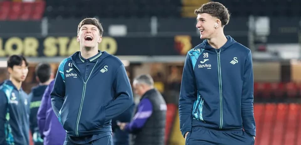Swansea City players laughing during warm-up session