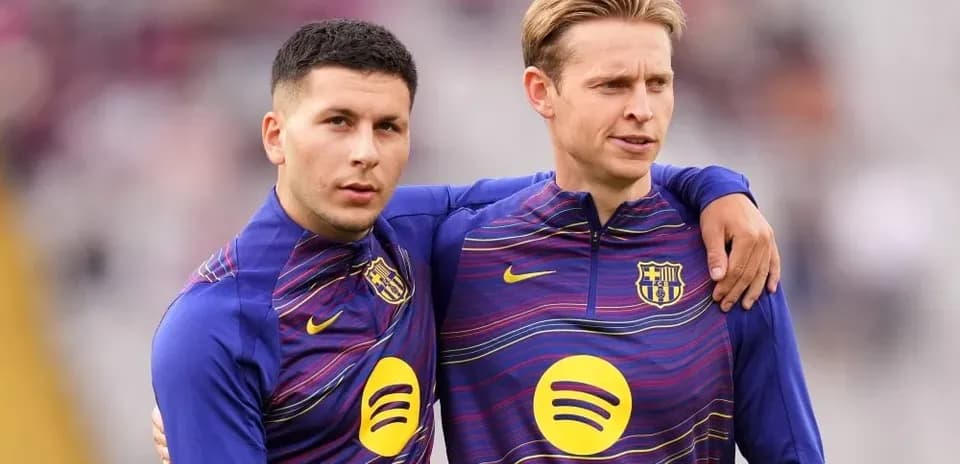 Two players in FC Barcelona training gear posing together