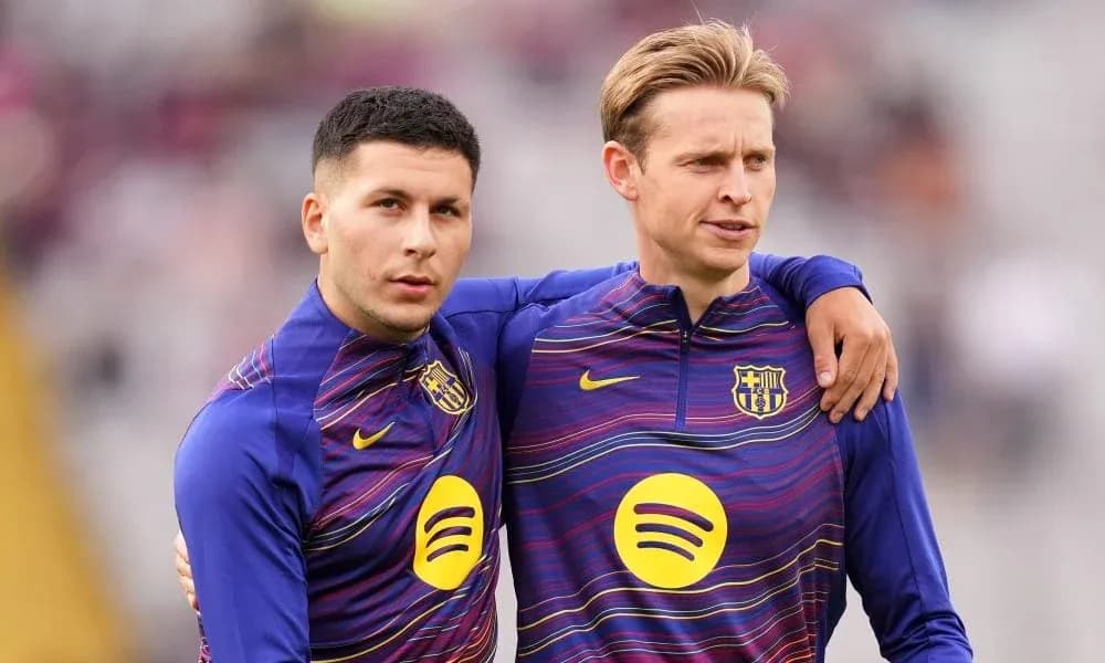 Two players in FC Barcelona training gear posing together
