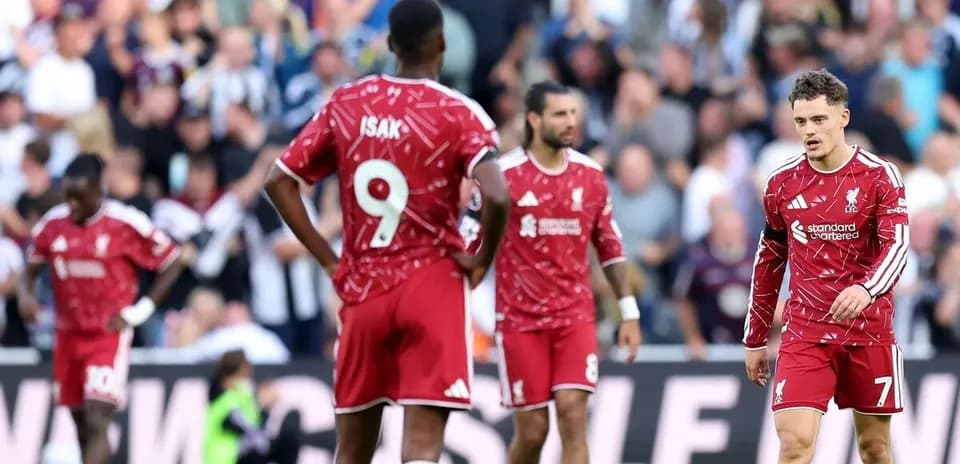 Liverpool players walking on pitch after match