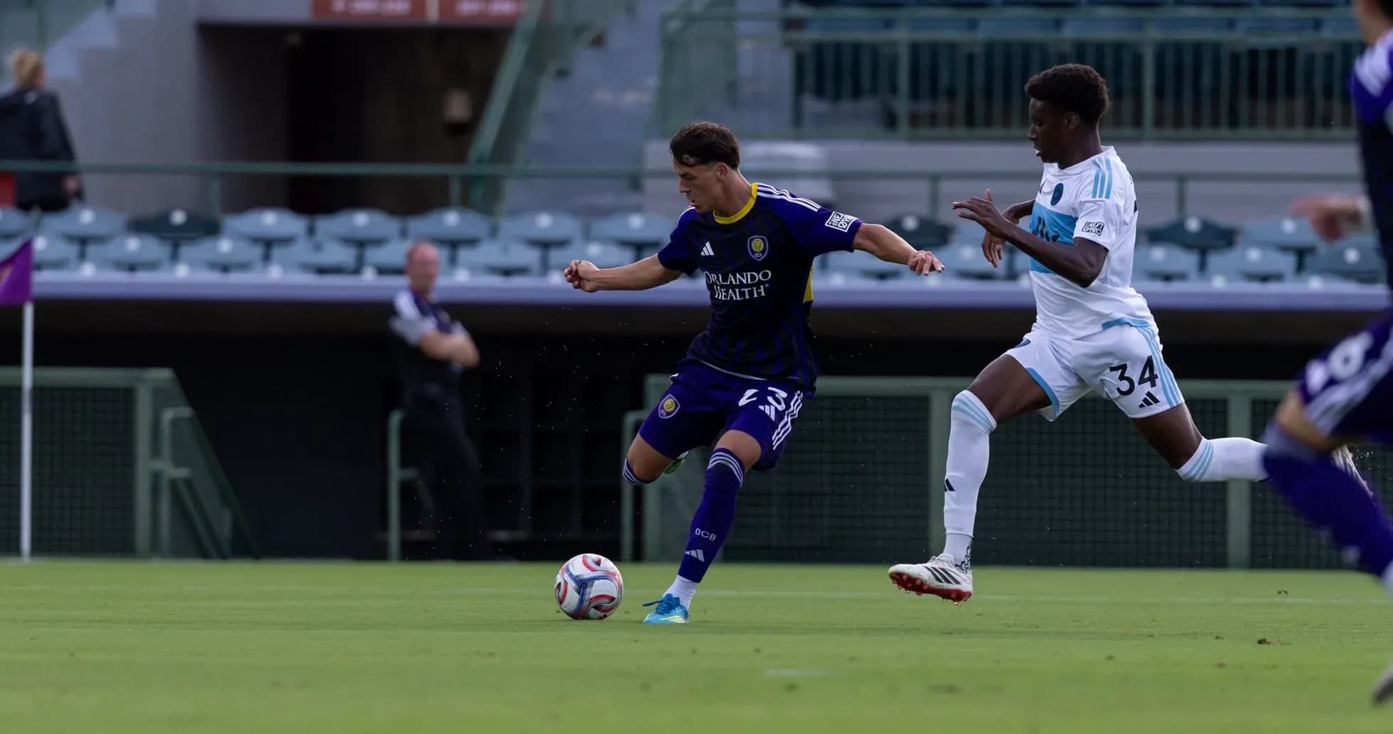 Orlando City II player dribbling past Crown Legacy opponent