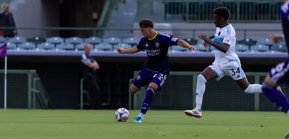 Orlando City II player dribbling past Crown Legacy opponent