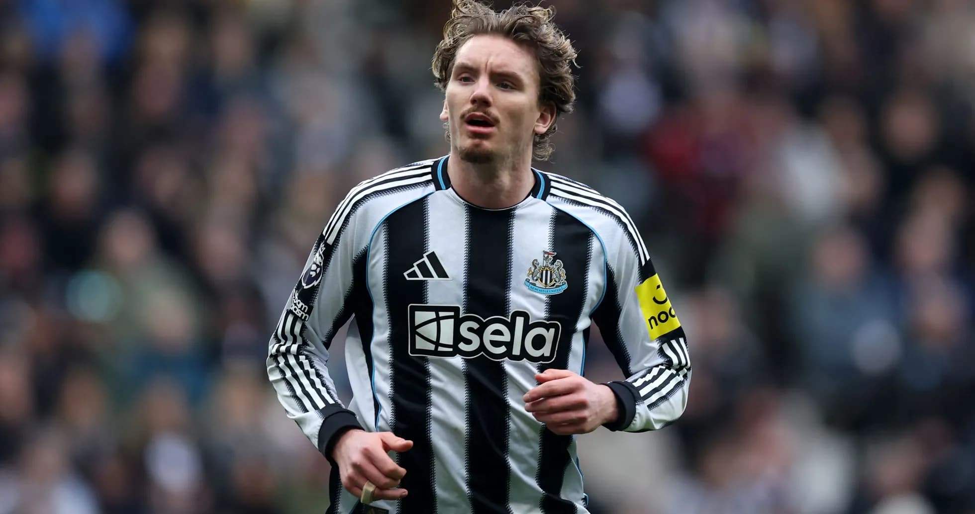 Player running in Newcastle United jersey during match