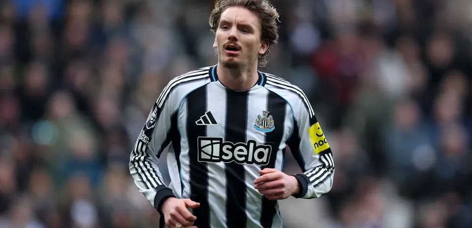 Player running in Newcastle United jersey during match