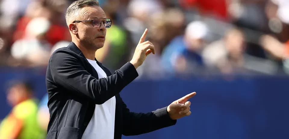 Coach gesturing during a match from the sideline