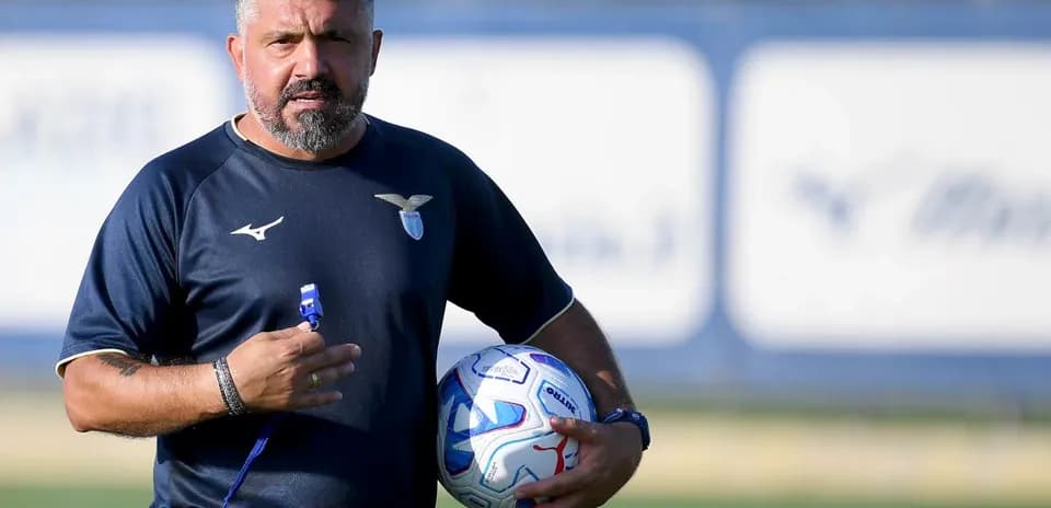 Coach holding a football during training session
