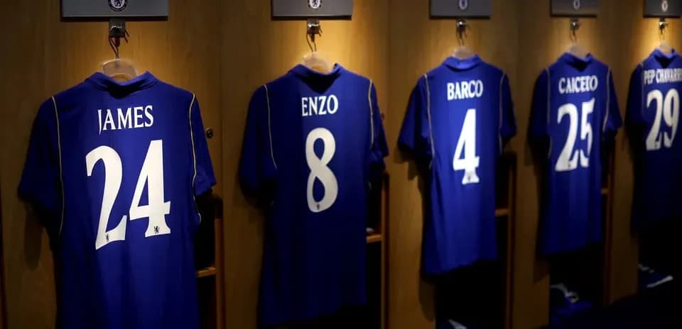 Chelsea jerseys hanging in locker room with names