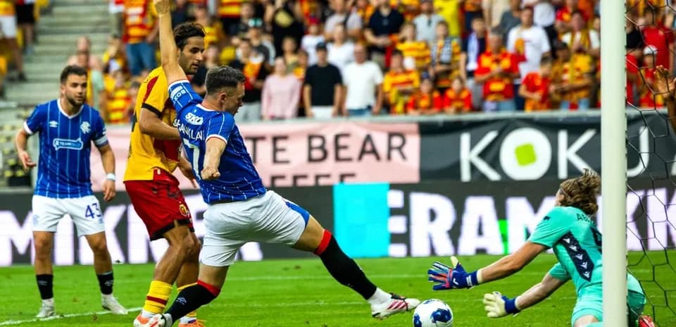 Jagiellonia player tackling Rangers forward in match