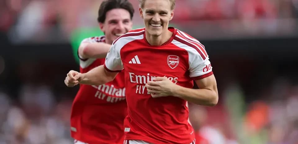 Arsenal players celebrating a goal on the field
