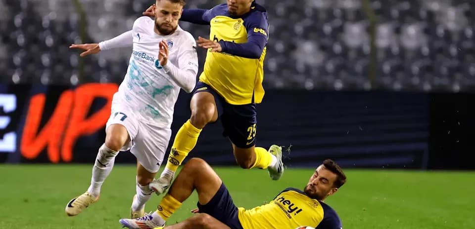 Player dribbling past defenders during football match