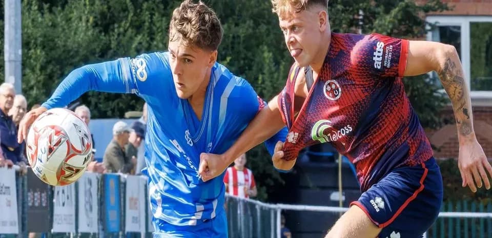 Two players battling for the ball during match