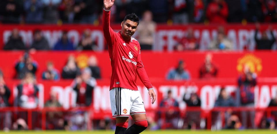Player waving to fans at Manchester United stadium
