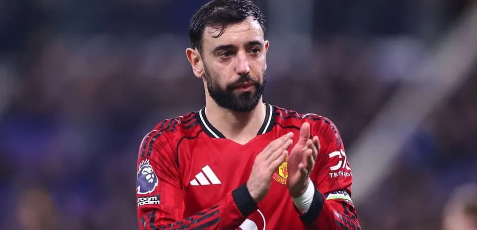Player applauding fans in Manchester United kit