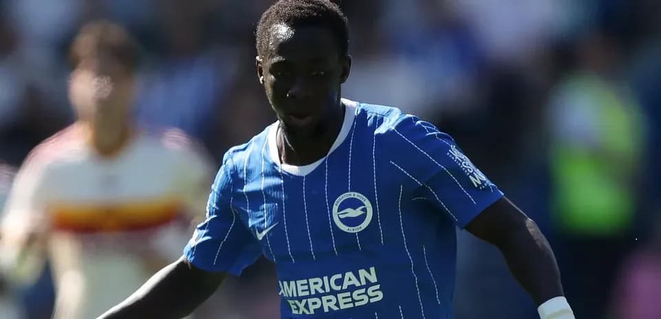 Player in blue kit running on the pitch