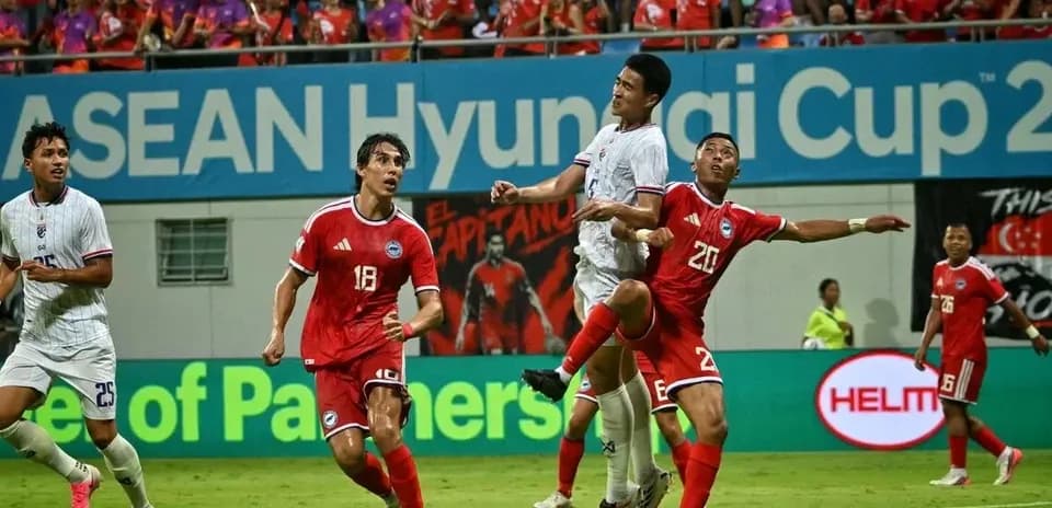 Players competing for the ball during ASEAN Cup match