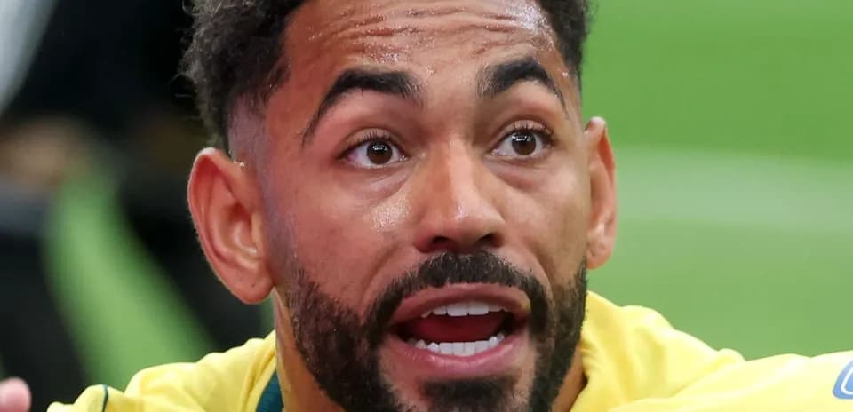 Player in yellow jersey expressing intensity during match