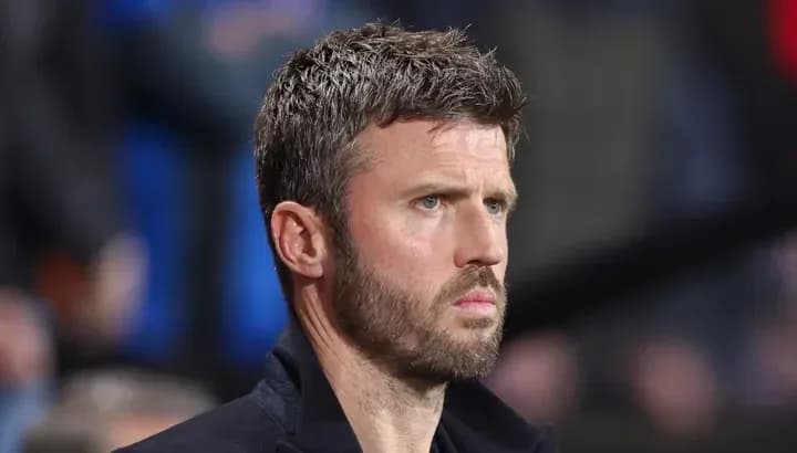 Man in a suit observing the match closely