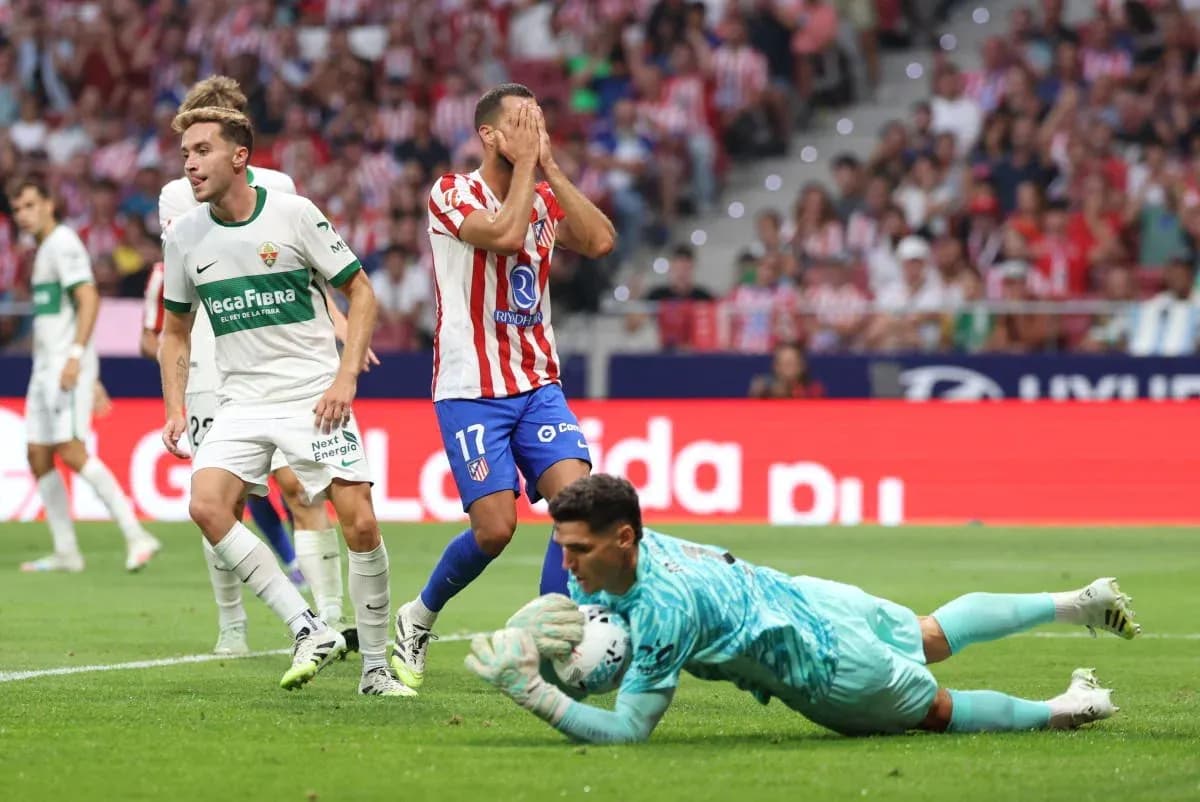Players from Elche and Atletico Madrid in action