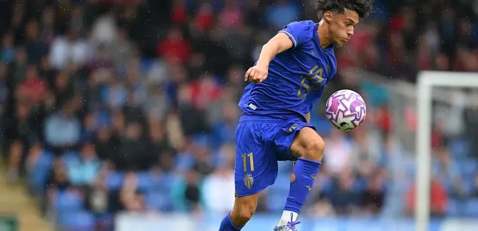 Player in blue jersey controlling a soccer ball