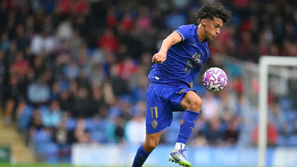 Player in blue jersey controlling a soccer ball