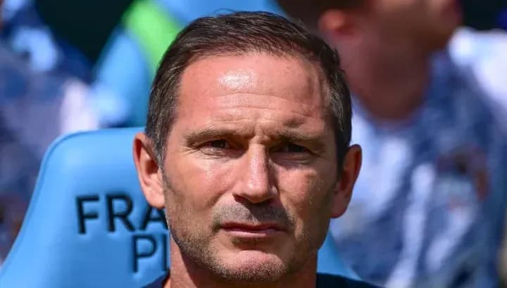 Coach sitting on bench during match