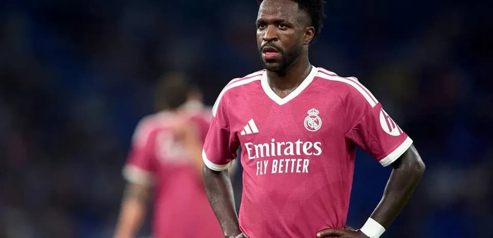 Player wearing pink Real Madrid jersey on field