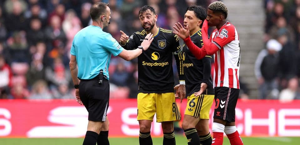 Players arguing with referee during a match
