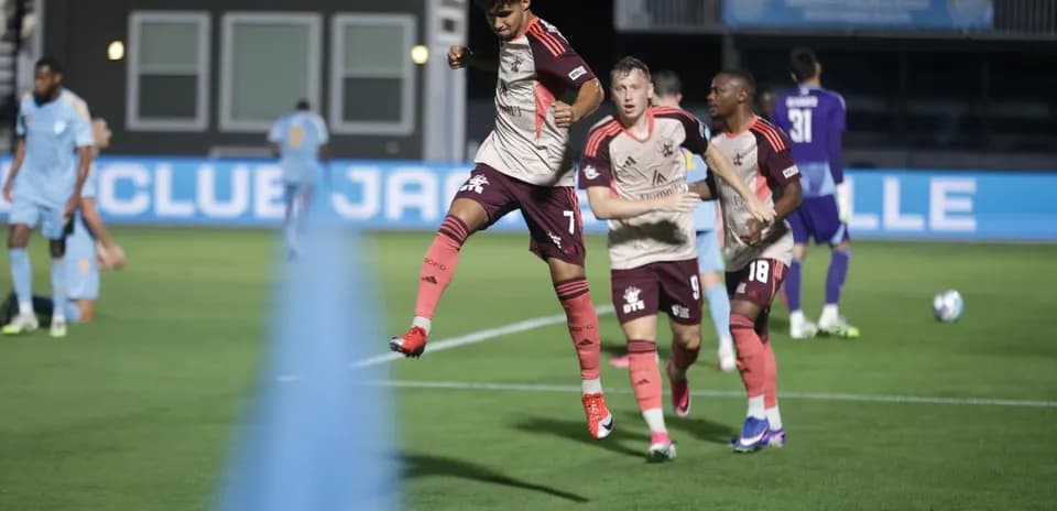 Detroit City players celebrating a goal during match