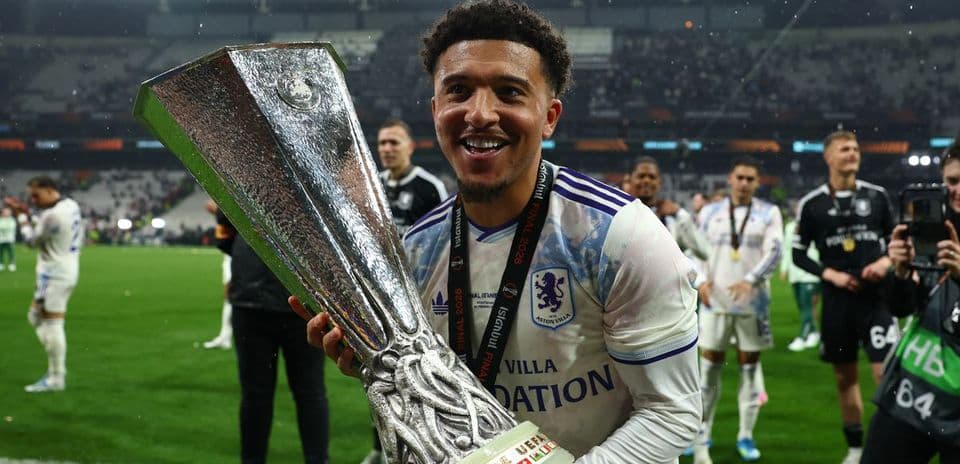 Player celebrating with UEFA trophy after match