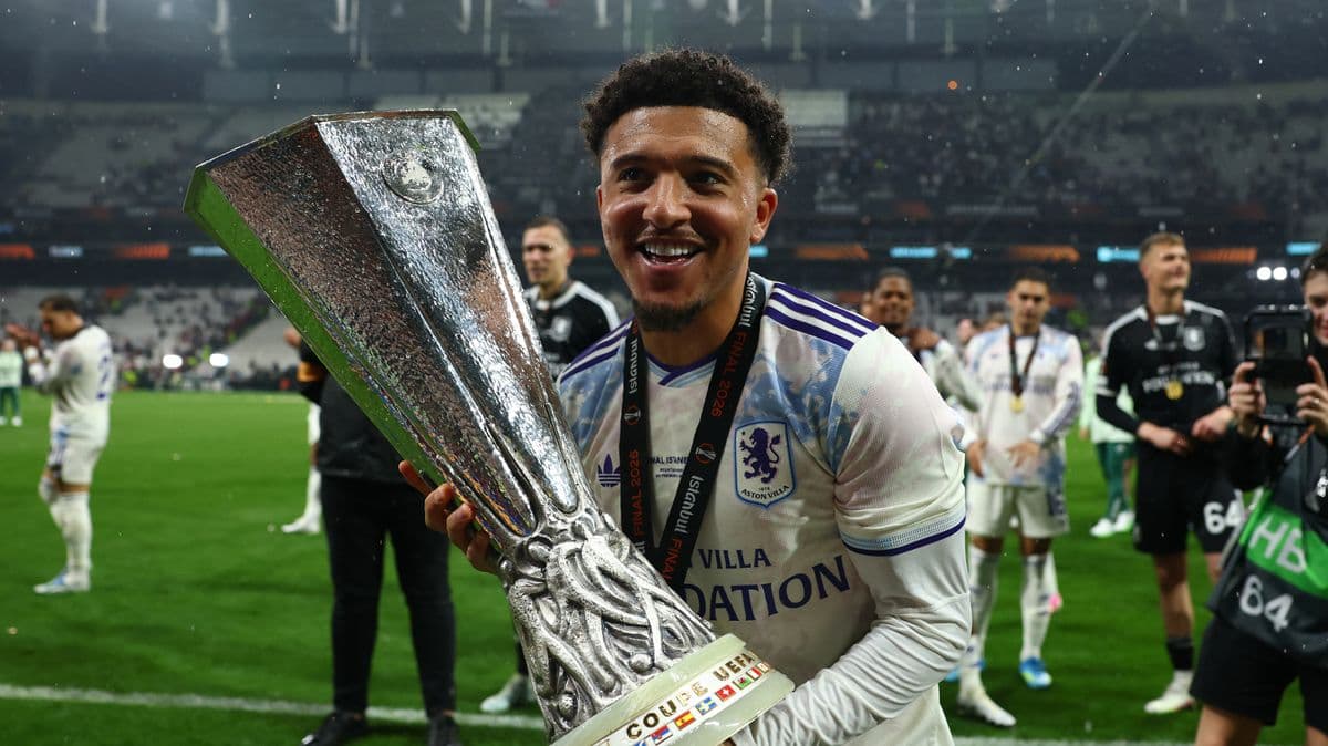 Player celebrating with UEFA trophy after match