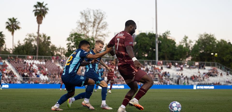Players competing for the ball in USL match