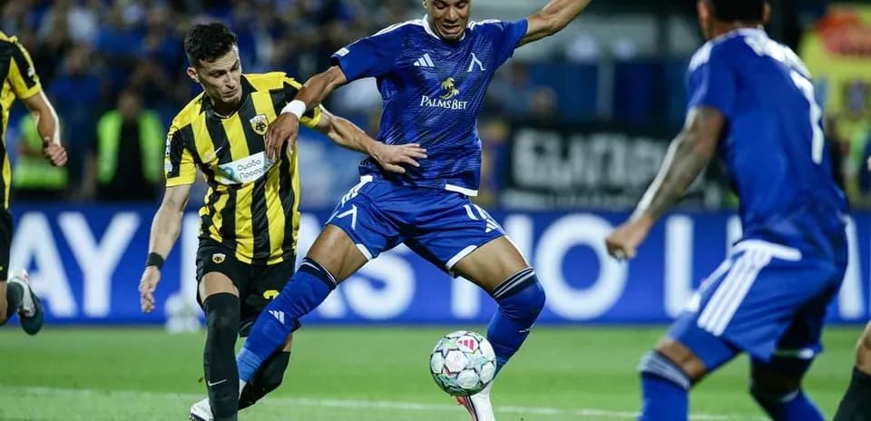 Levski Sofia player dribbling past AEK Athens opponent