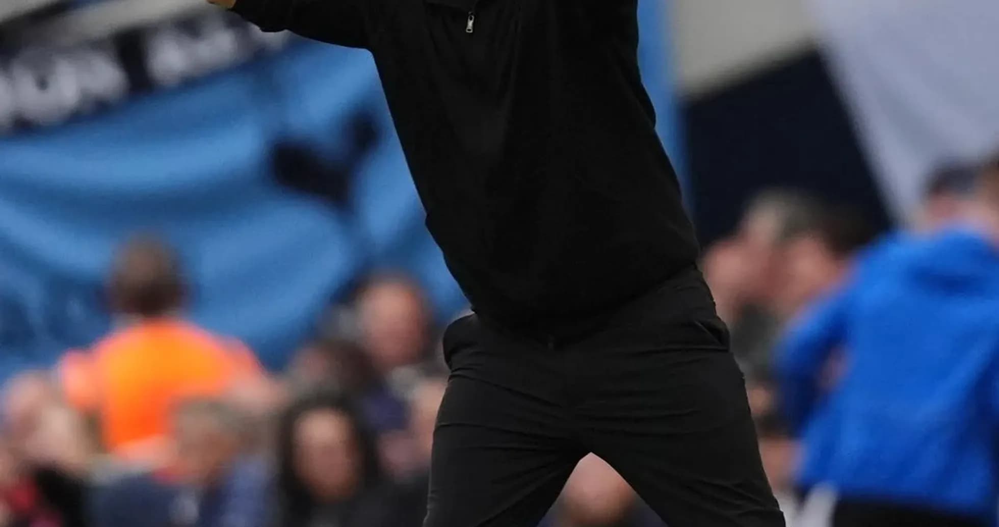 Coach directing players from the sidelines during match