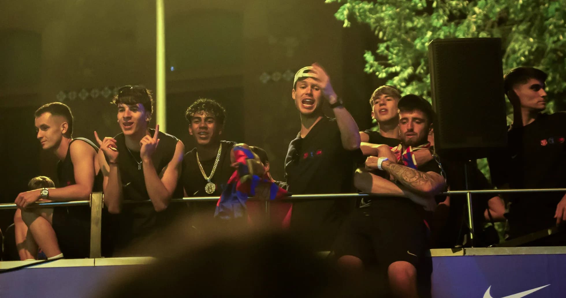 Group of fans celebrating on a balcony