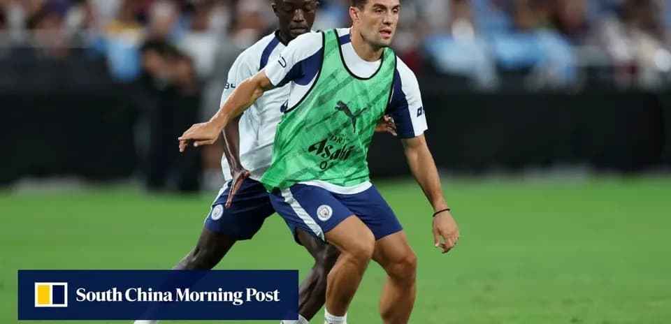 Two players training with a football on the pitch