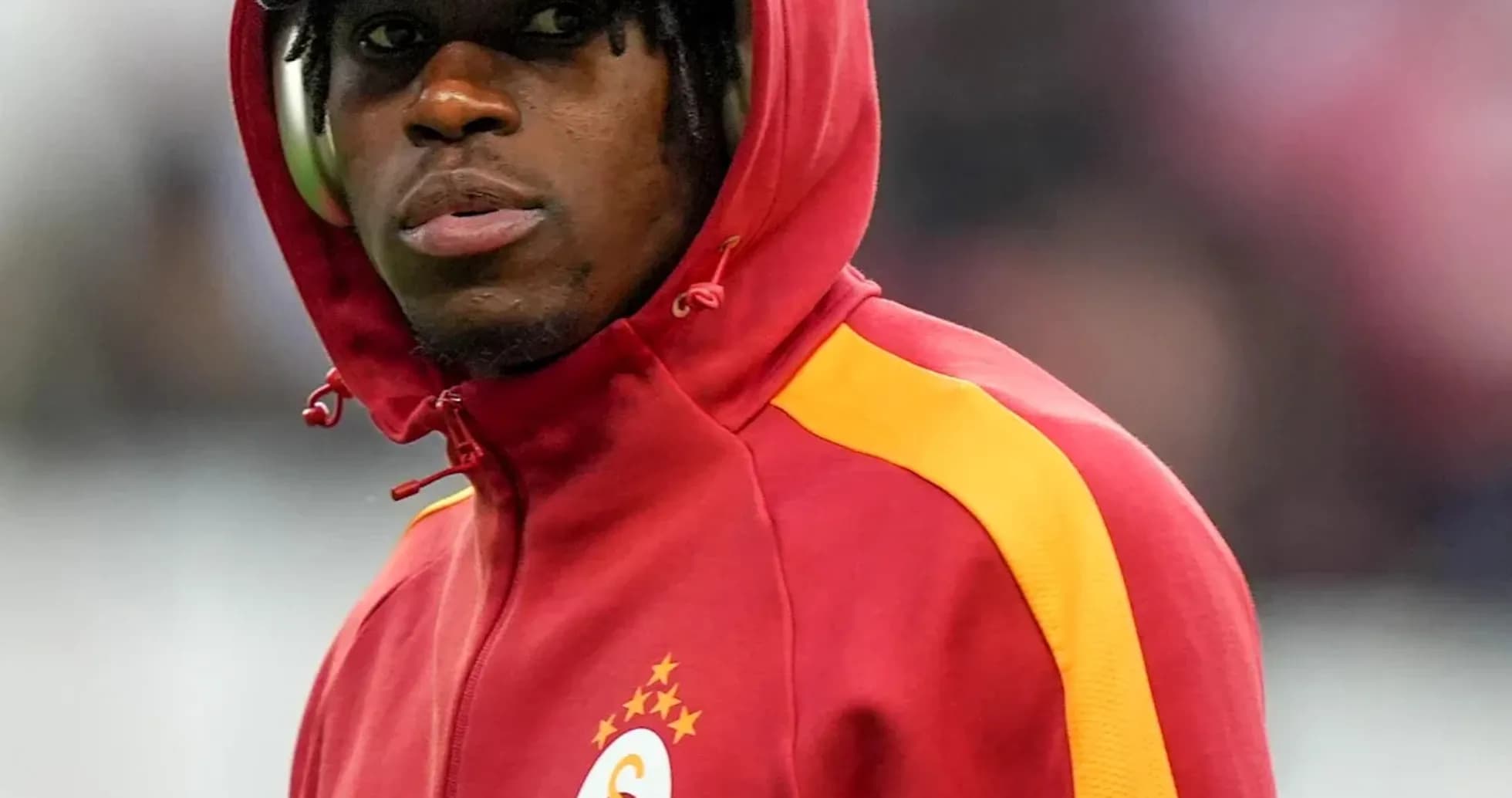 Player wearing a hooded jacket before the match
