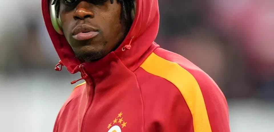 Player wearing a hooded jacket before the match
