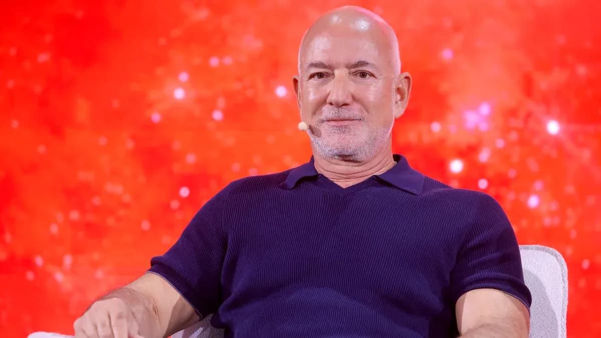 Man sitting on stage with red background