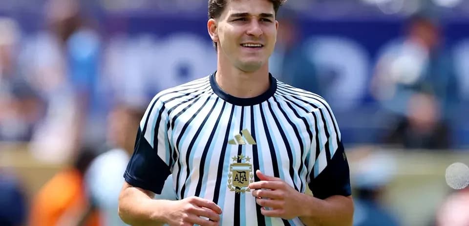 Player wearing striped Argentina jersey on field