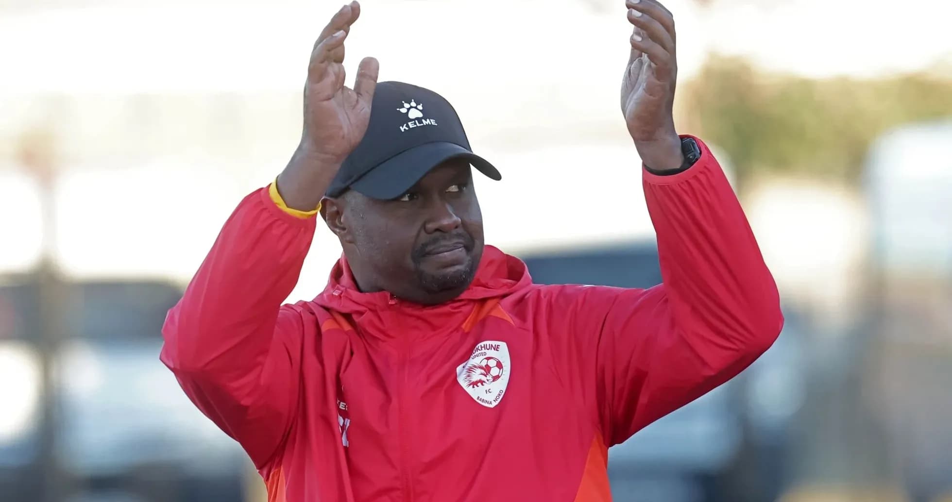 Coach gesturing during training session at field