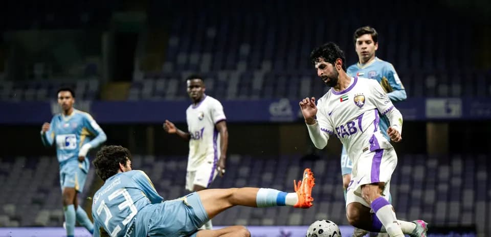 Player tackling opponent during Al Dhafra vs Al Ain match