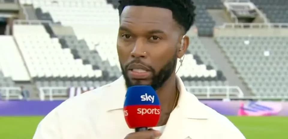 Presenter speaking into microphone at stadium