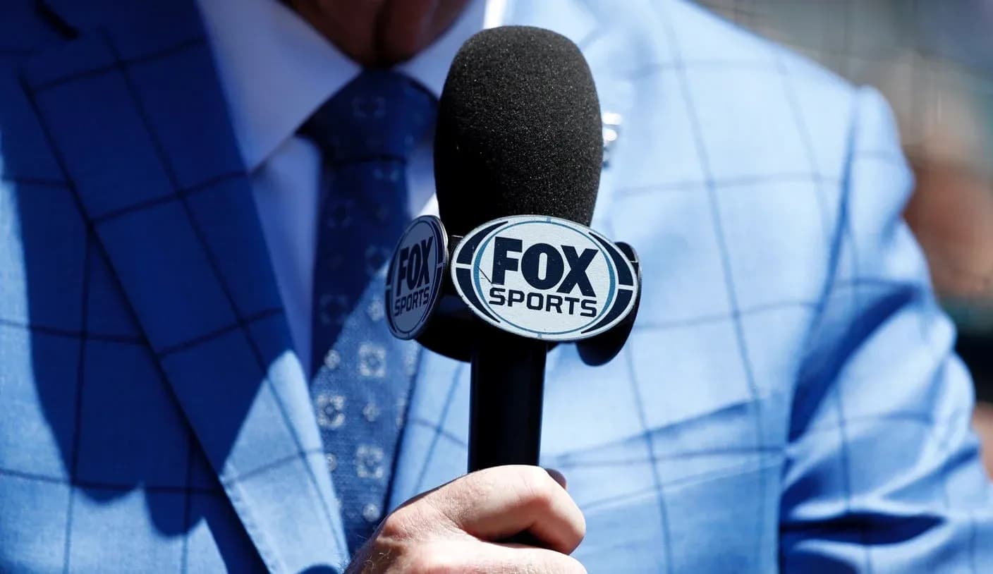 Microphone with FOX Sports logo held in hand