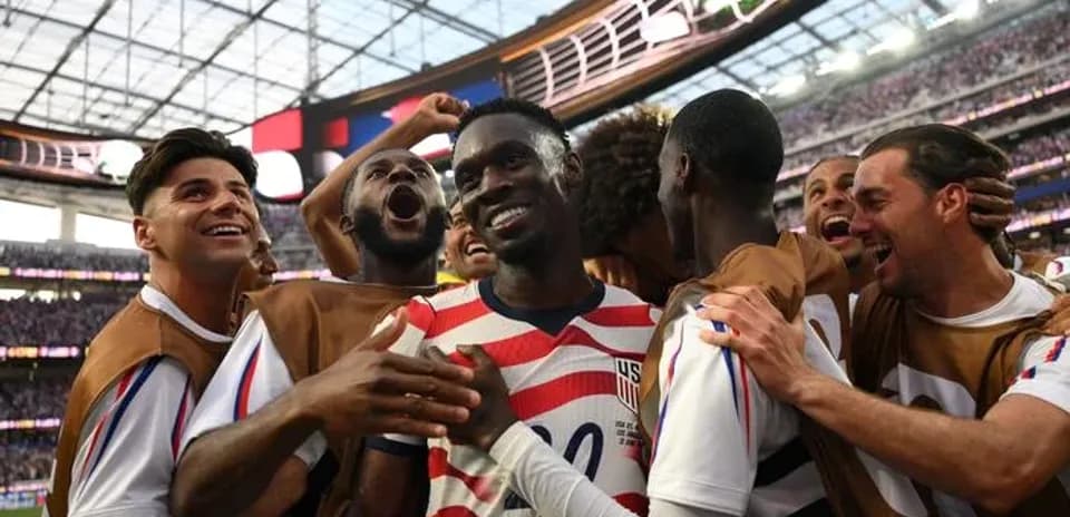 US men's soccer team celebrating a goal together